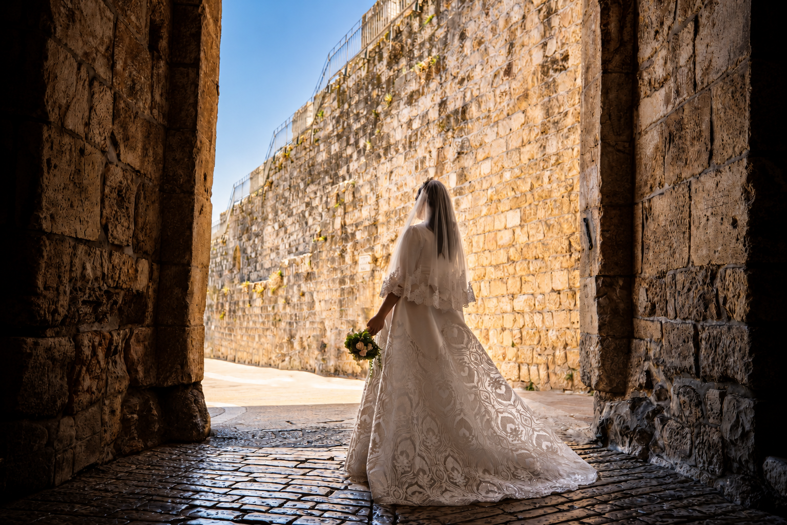 A bride beneath a stone archway